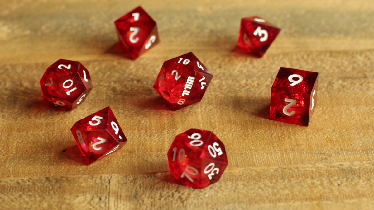 Seven multi-shaped translucent red dice with a liquid glitter core.